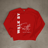 Red sweatshirt with 'Walk by Faith not by sight' text on a gray surface
