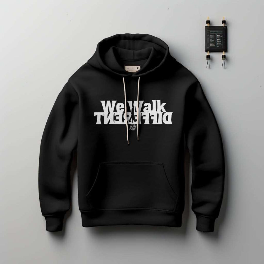 Person wearing "We Walk Different" hoodie inspired by 2 Corinthians 5:7 walking confidently outdoors