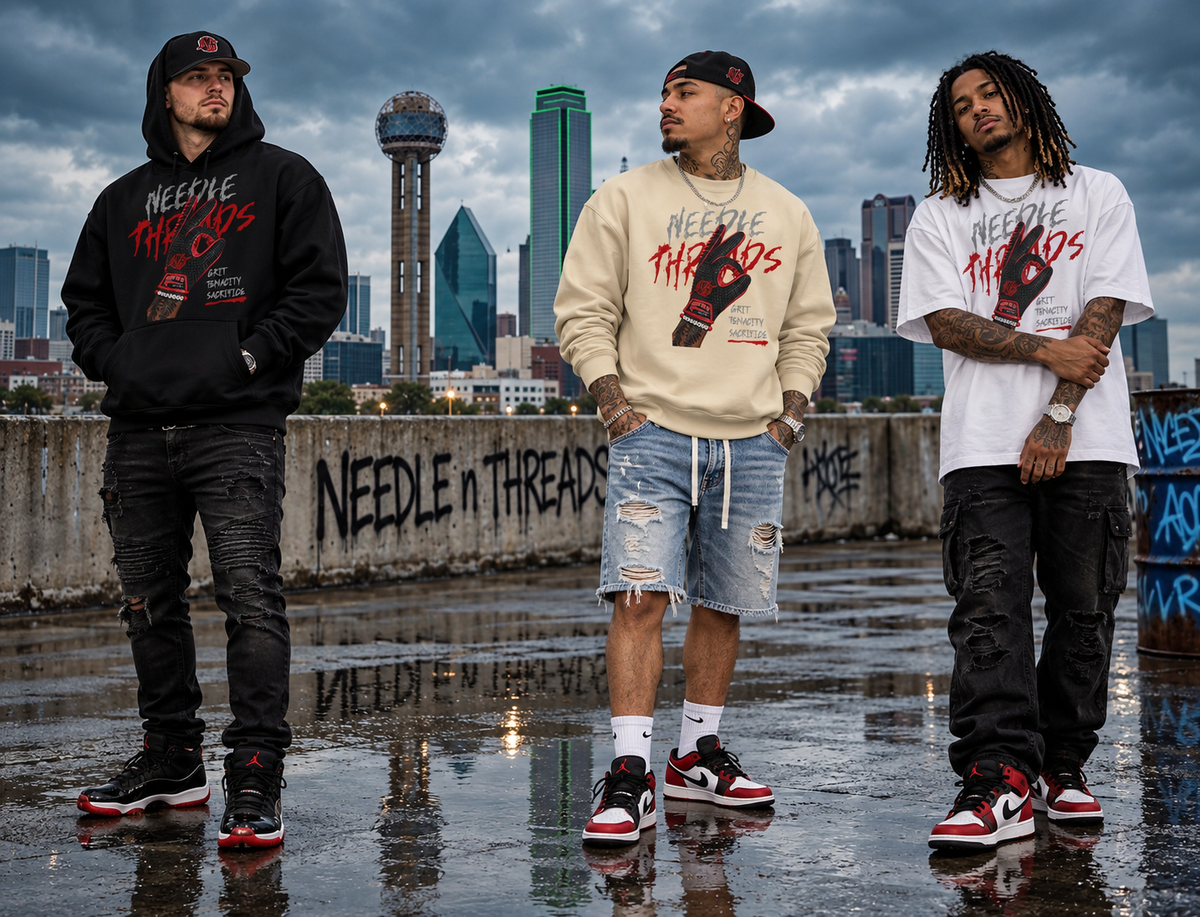 Three men standing on a wet rooftop with a city skyline in the background, wearing matching Needle & Thread brand streetwear outfits including graphic hoodies, t-shirts, jeans, and sneakers.
