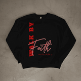 Black sweatshirt with red and white text on a concrete floor